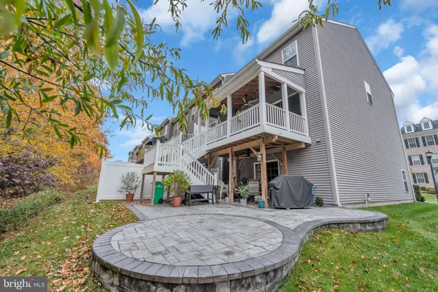 a kitchen with stainless steel appliances granite countertop a table chairs sink refrigerator and cabinets