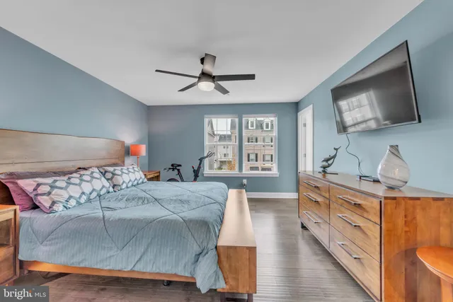 a bathroom with a double vanity sink a toilet a mirror and shower