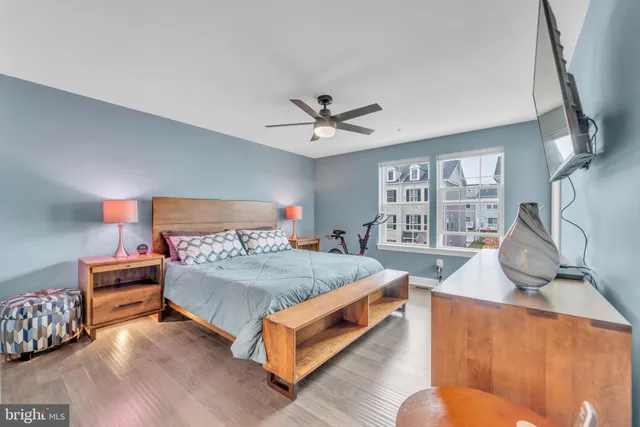 an empty room with closet and a chandelier fan