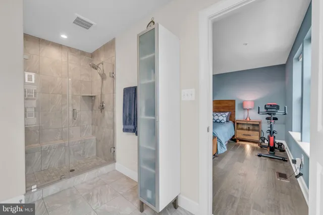 a bed sitting in a bedroom next to a window