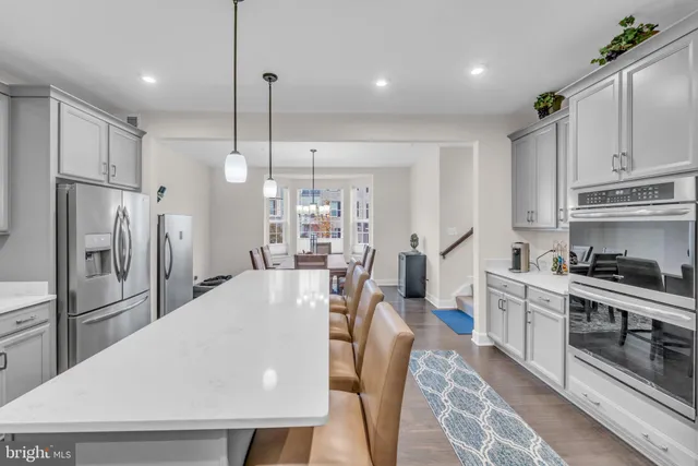 a kitchen with stainless steel appliances a sink stove and cabinets