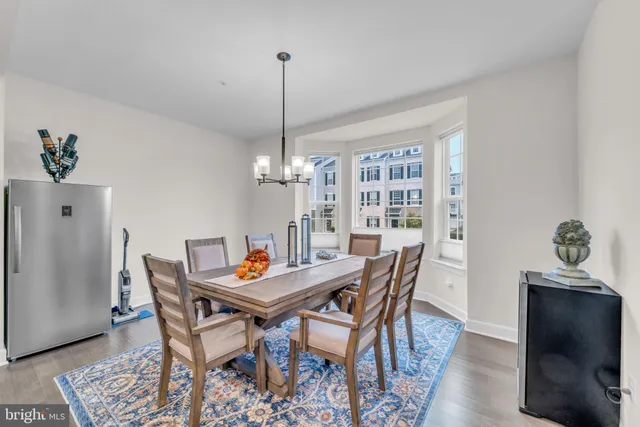 a view of kitchen with stainless steel appliances cabinets and wooden floor