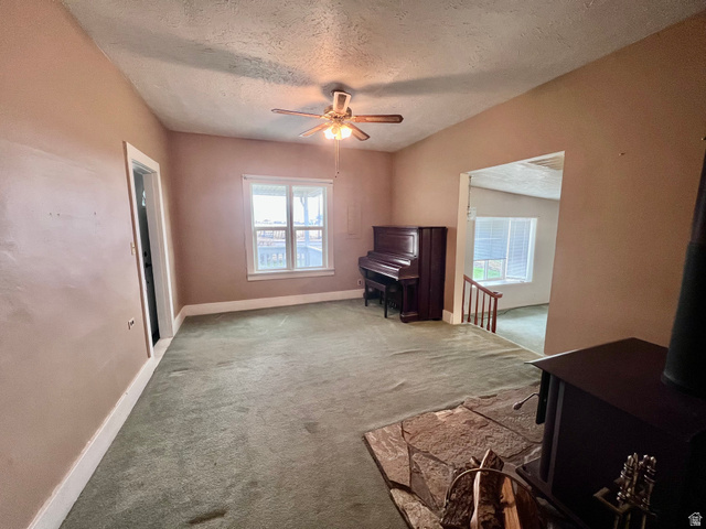 479 East 100 N Road Meadow, UT 84644 - Photo 8 of 59 Unfurnished room with ceiling fan, light carpet, and a textured ceiling