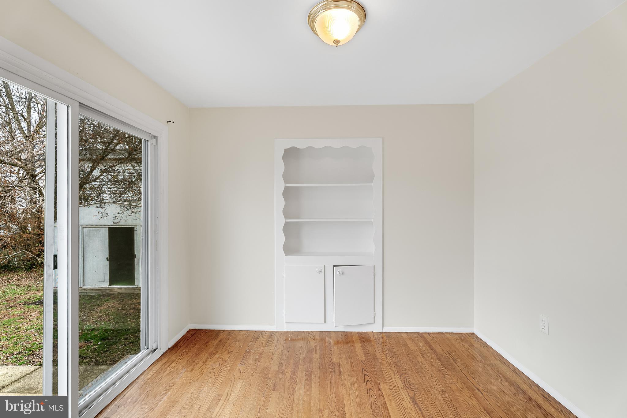 264 Old Line Avenue Laurel, MD 20724 - Photo 12 of 31 a view of empty room with wooden floor and fan