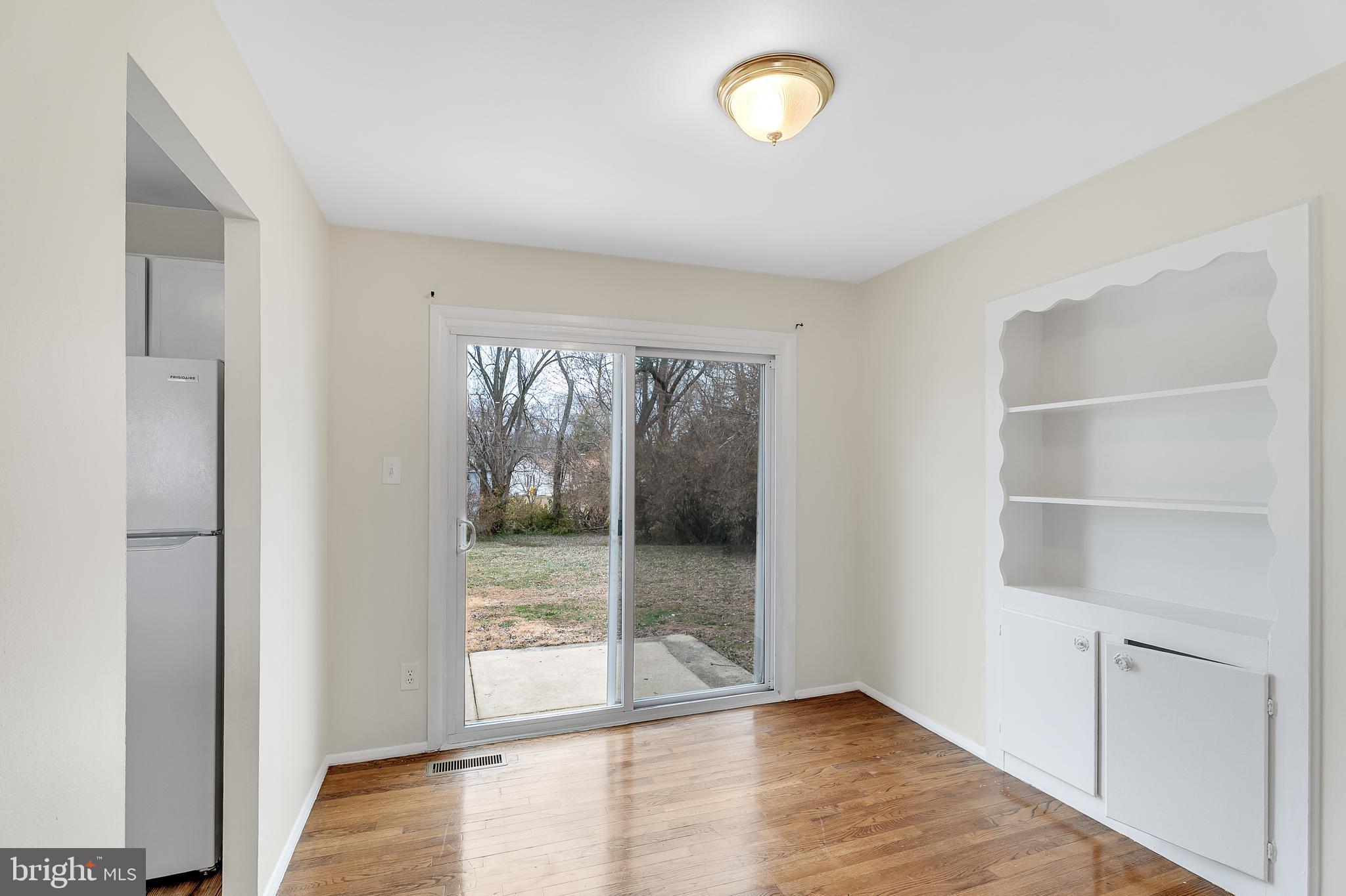 264 Old Line Avenue Laurel, MD 20724 - Photo 13 of 31 a view of an empty room with wooden floor and a window