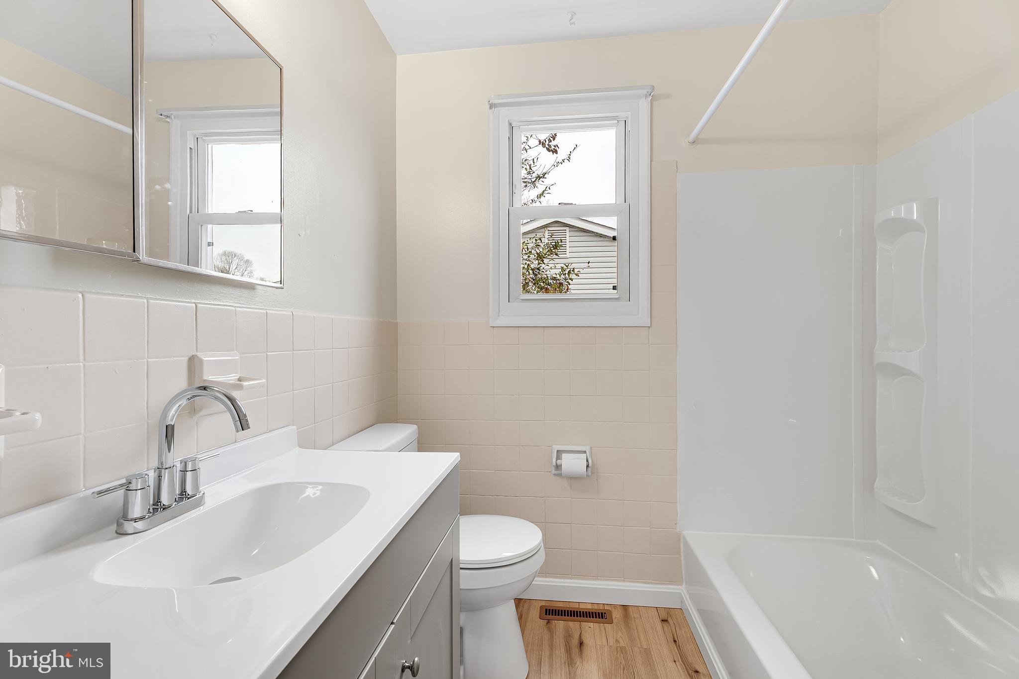 264 Old Line Avenue Laurel, MD 20724 - Photo 18 of 31 a bathroom with a sink a toilet and shower