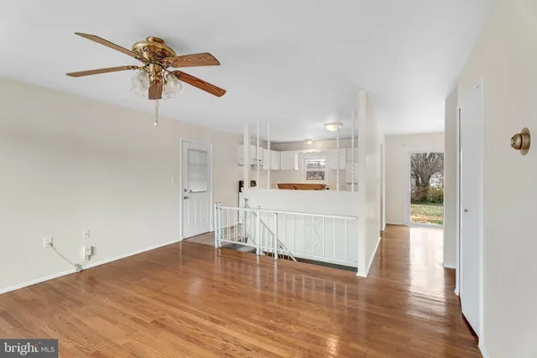 a view of a living room and kitchen with wooden floor