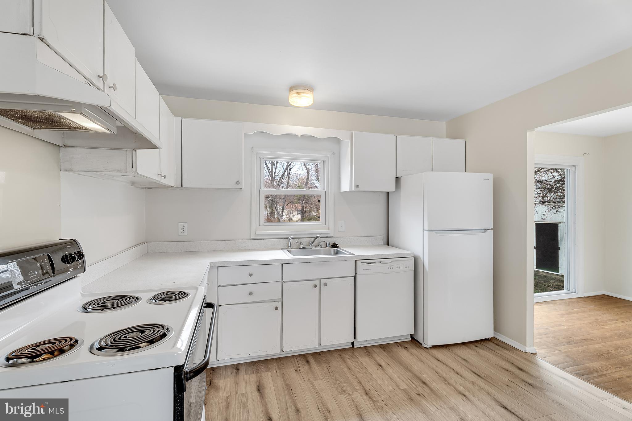 264 Old Line Avenue Laurel, MD 20724 - Photo 8 of 31 a kitchen with a sink a refrigerator and cabinets