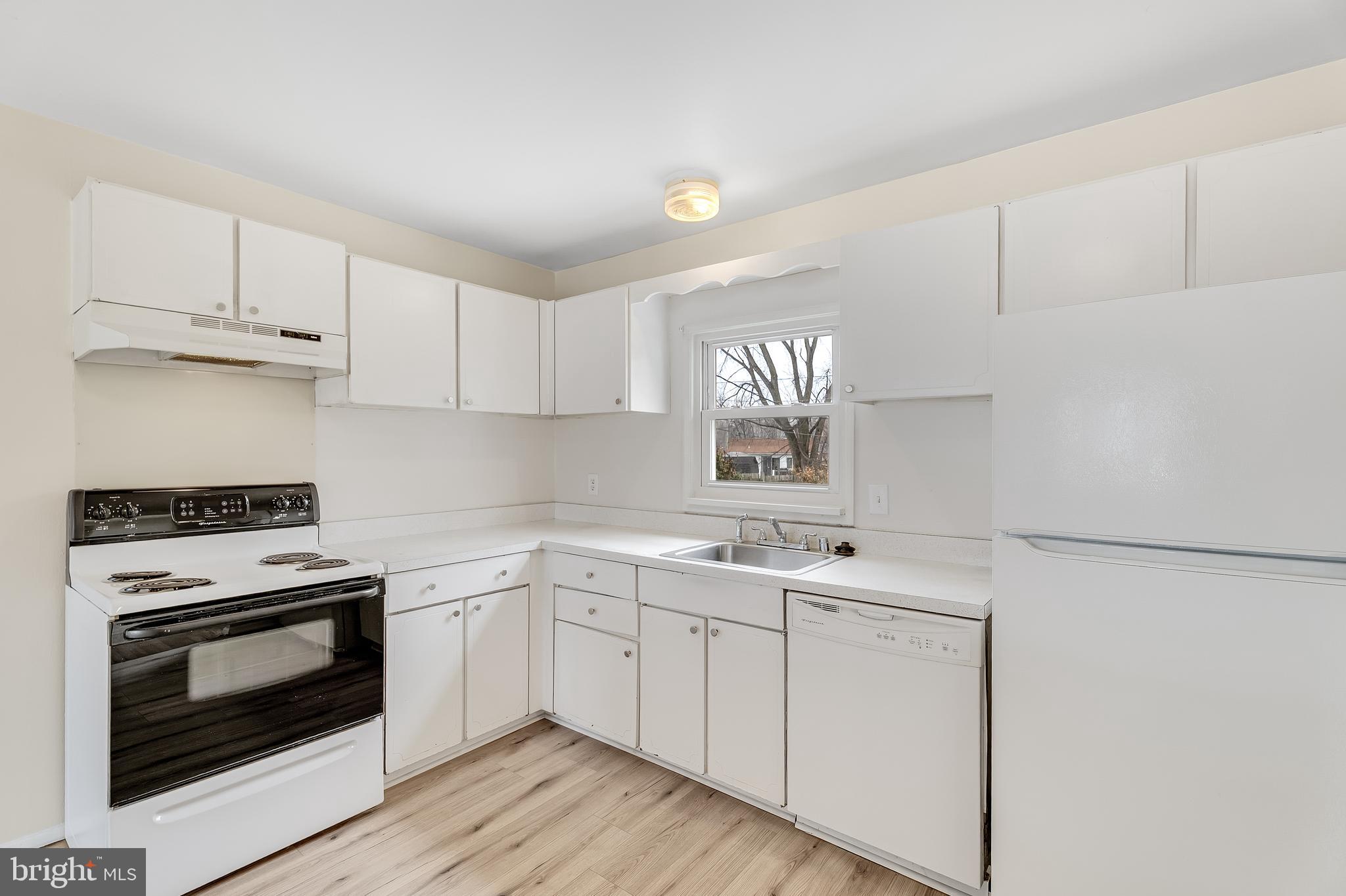264 Old Line Avenue Laurel, MD 20724 - Photo 9 of 31 a kitchen with cabinets appliances a sink and a window