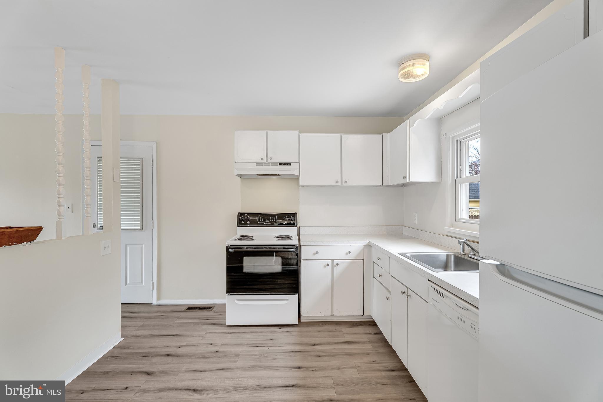 264 Old Line Avenue Laurel, MD 20724 - Photo 10 of 31 a kitchen with stainless steel appliances sink a stove and cabinets