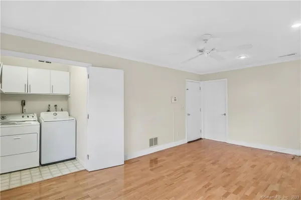 a view of a kitchen with wooden floor and cabinet