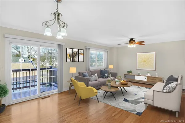 a living room with furniture wooden floor and a chandelier