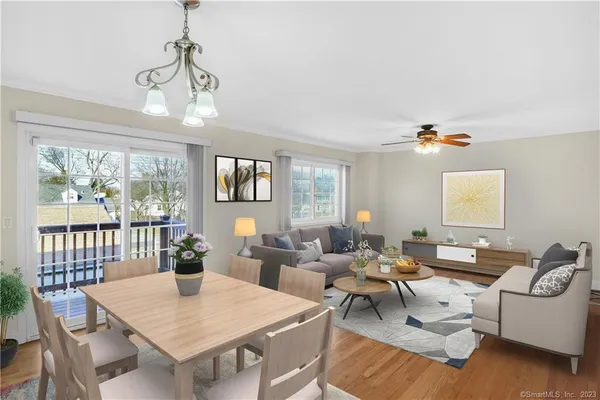 a living room with furniture a chandelier and a table