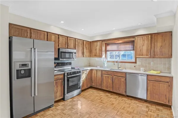 a kitchen with a sink stove and refrigerator
