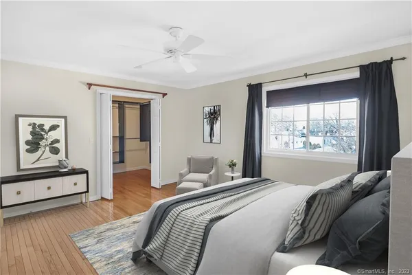 a bedroom with a large bed and a window