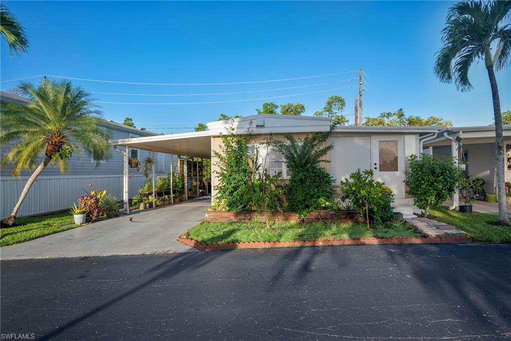 777 Walkerbilt Road, Unit 34 Naples, FL 34110 - Photo 2 of 23 Front of home featuring Carport