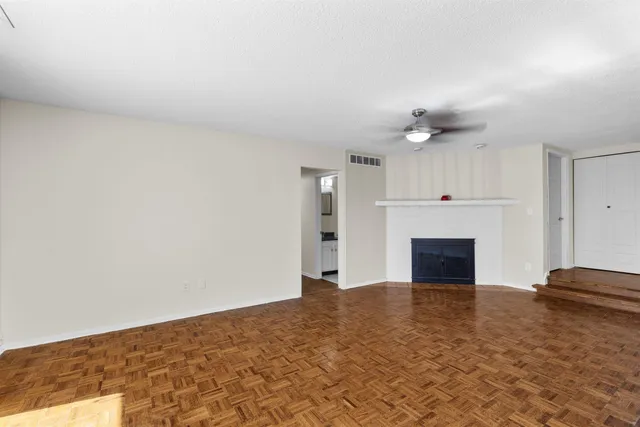 a view of empty room with a fireplace
