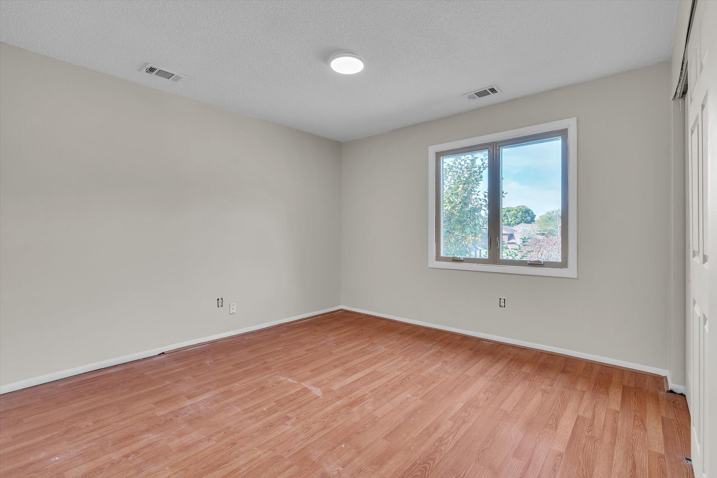 2521 East Lakeshore Drive Crown Point, IN 46307 - Photo 18 of 31 an empty room with wooden floor and windows