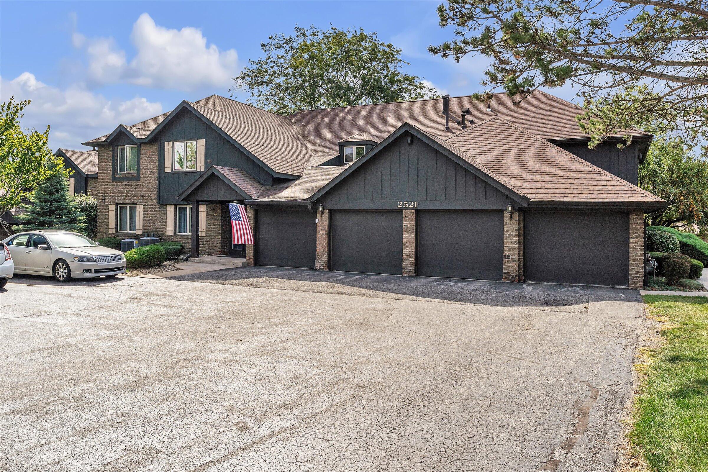 2521 East Lakeshore Drive Crown Point, IN 46307 - Photo 2 of 31 a front view of a house with a yard and garage