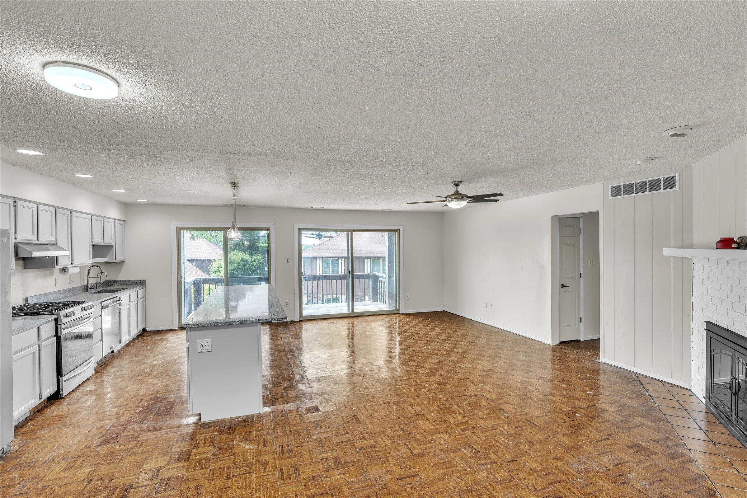 2521 East Lakeshore Drive Crown Point, IN 46307 - Photo 4 of 31 an empty room with windows and chandelier fan