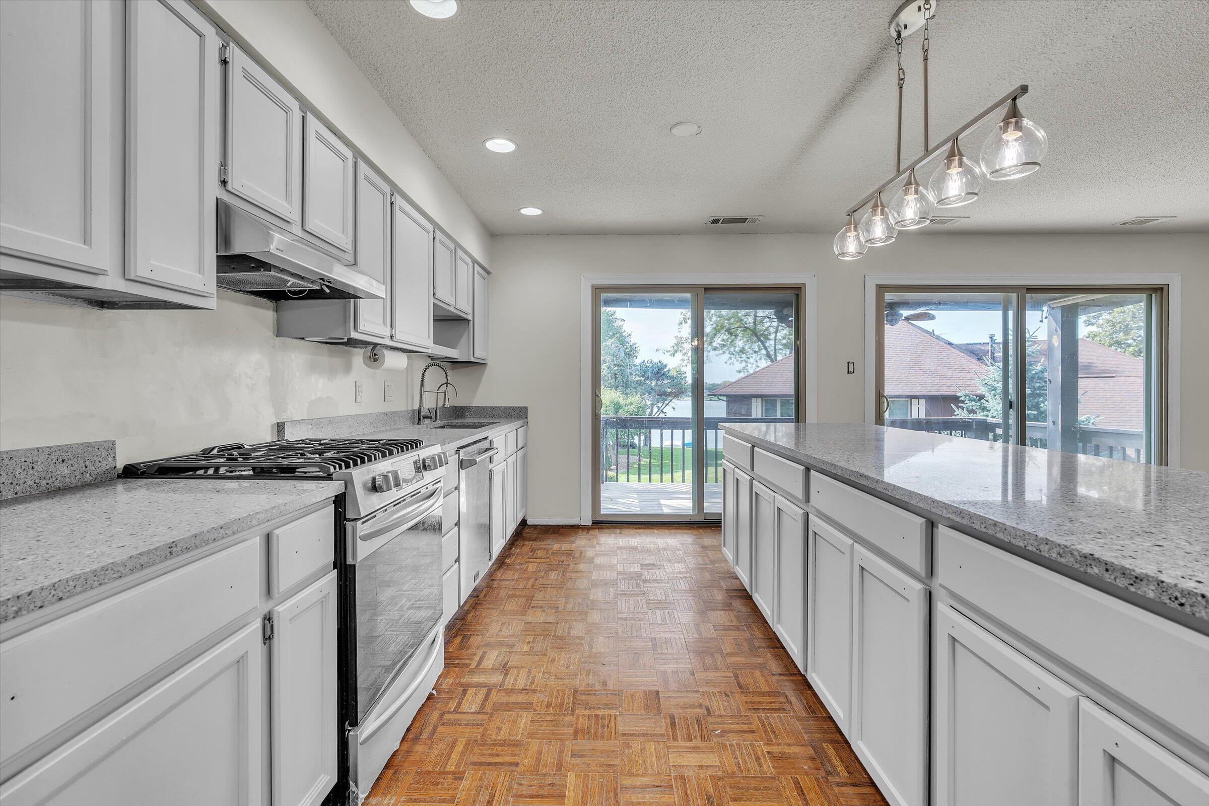 2521 East Lakeshore Drive Crown Point, IN 46307 - Photo 7 of 31 a large kitchen with stainless steel appliances granite countertop a stove and a sink