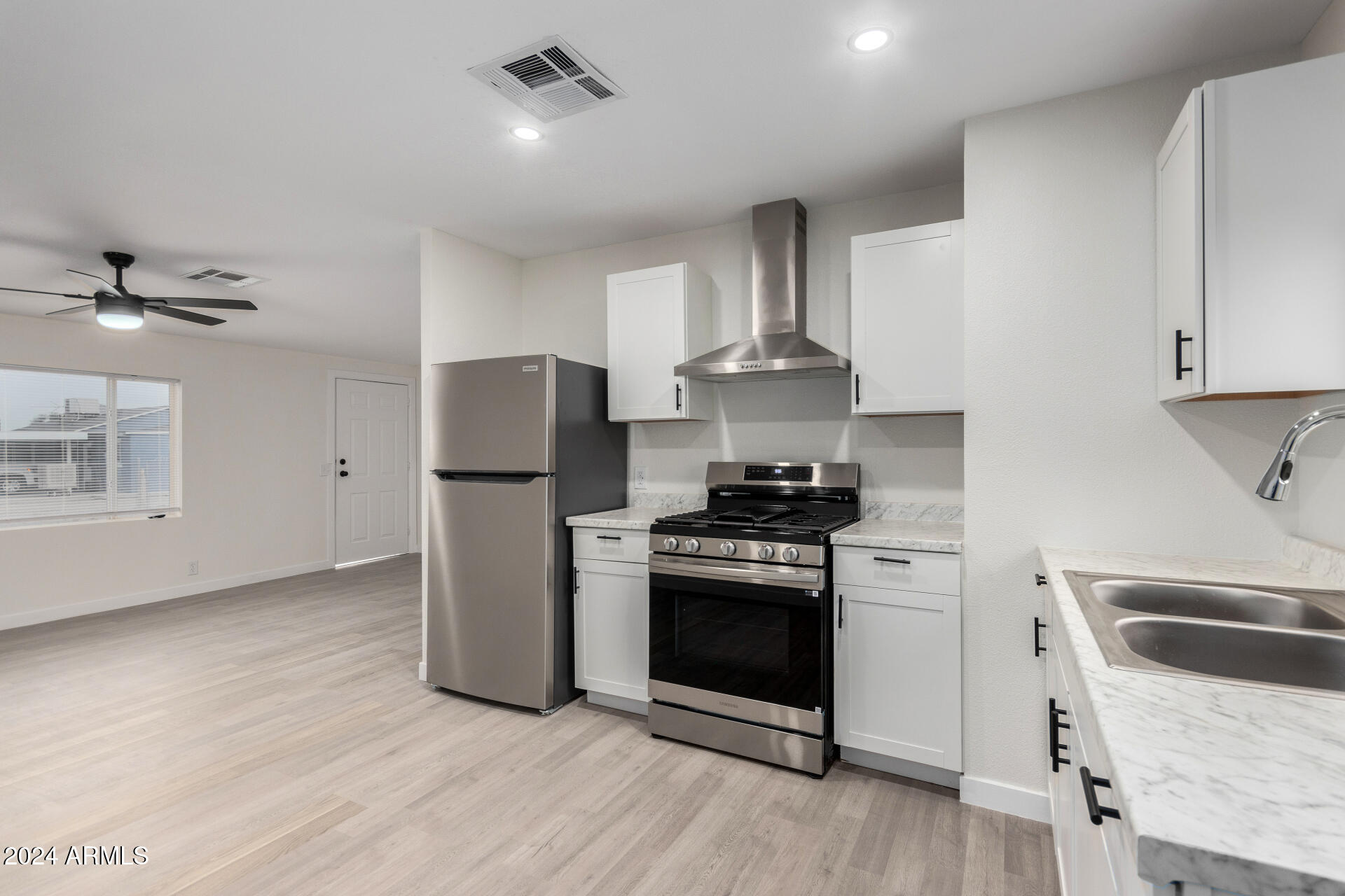 204 East Baseline Road Buckeye, AZ 85326 - Photo 12 of 29 a kitchen with stainless steel appliances granite countertop a stove a refrigerator and a sink