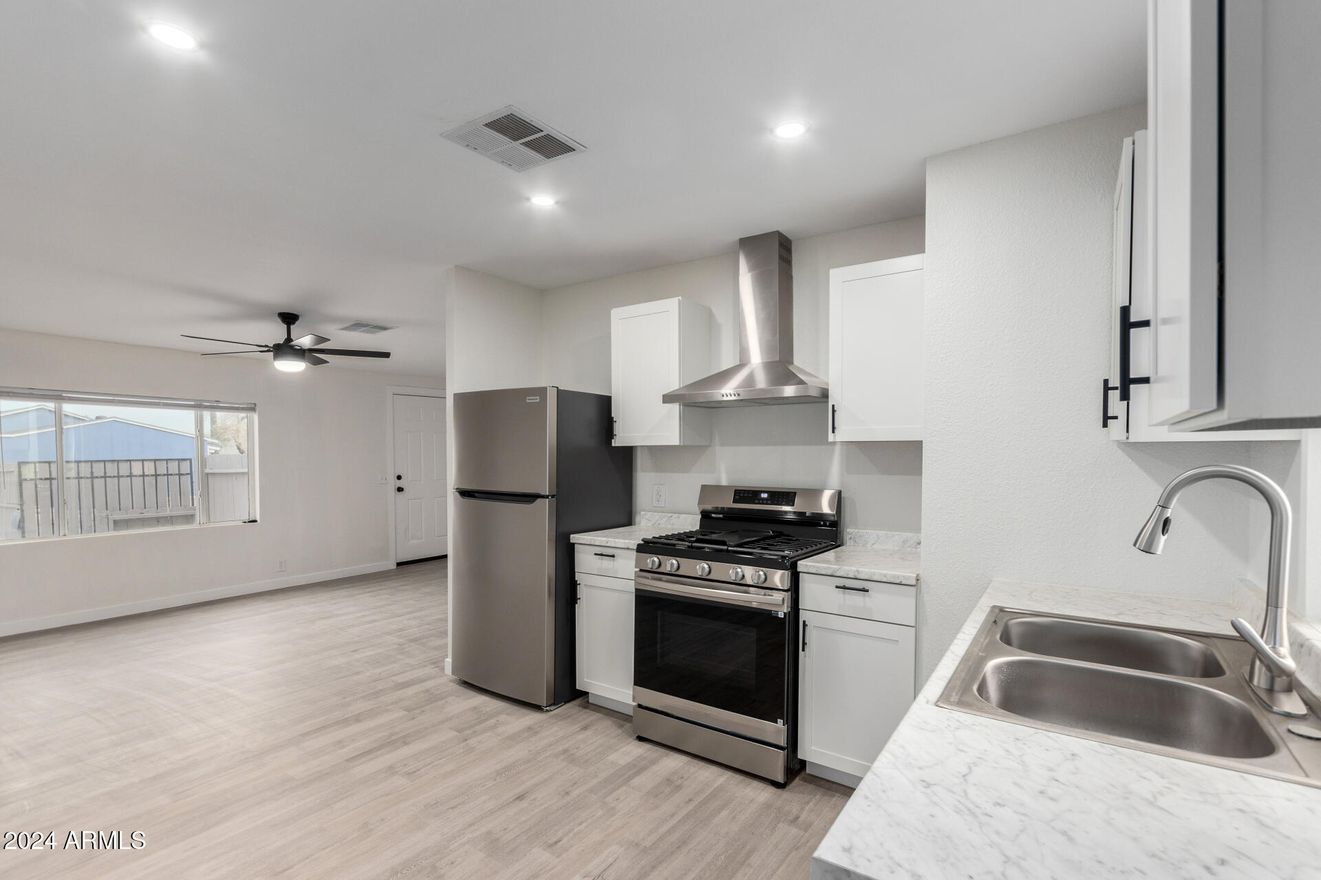 204 East Baseline Road Buckeye, AZ 85326 - Photo 13 of 29 a kitchen that has a sink stainless steel appliances a counter space and a window
