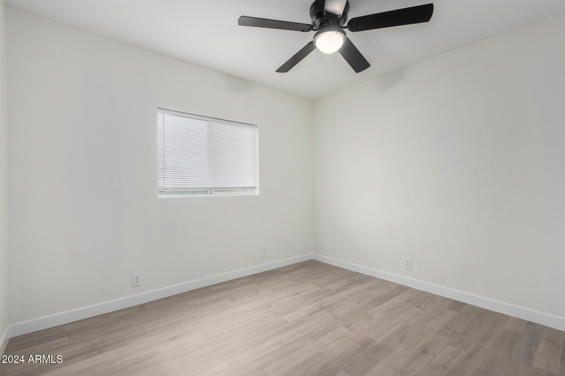 204 East Baseline Road Buckeye, AZ 85326 - Photo 14 of 29 an empty room with a window and a fan