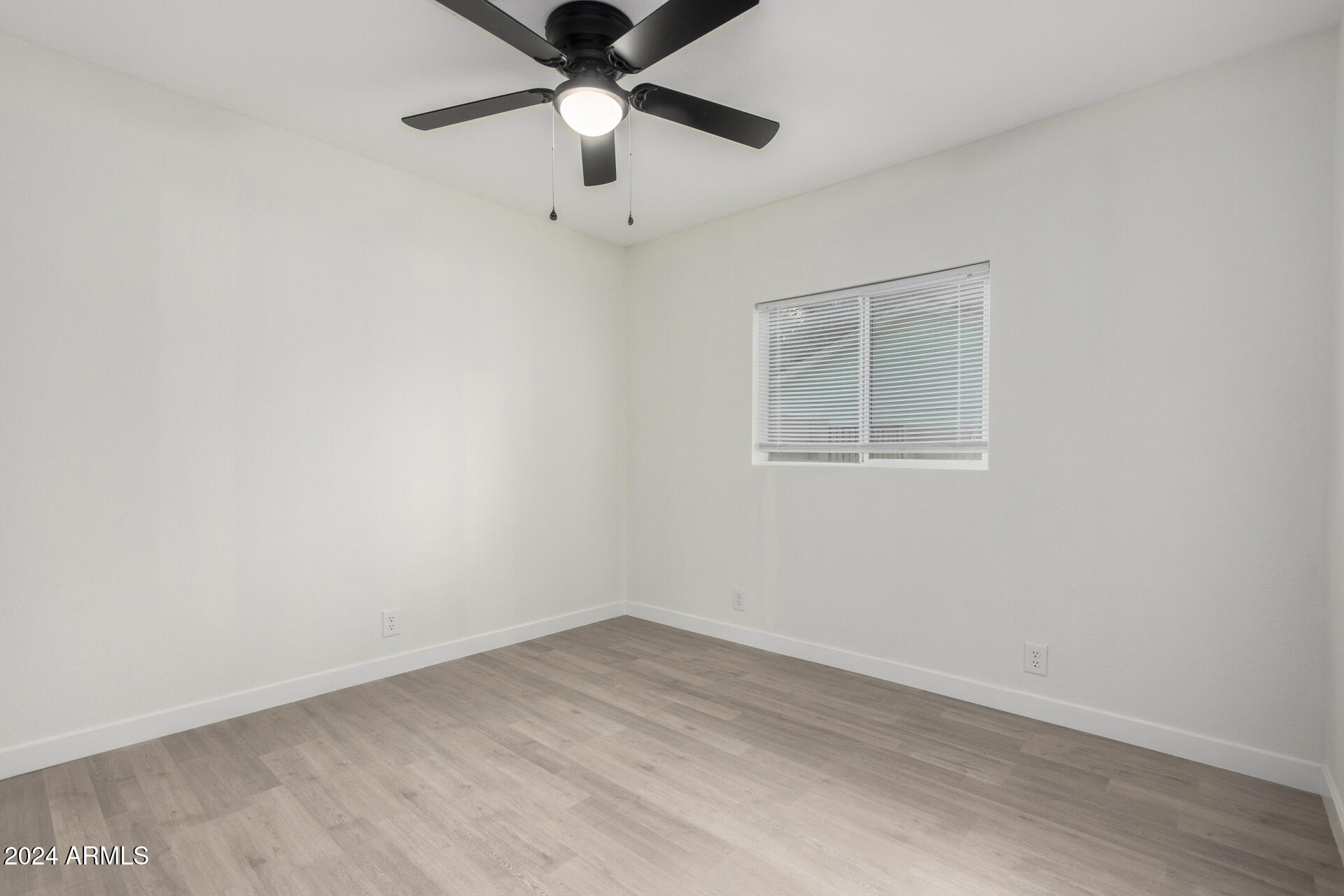 204 East Baseline Road Buckeye, AZ 85326 - Photo 16 of 29 an empty room with a window and a fan