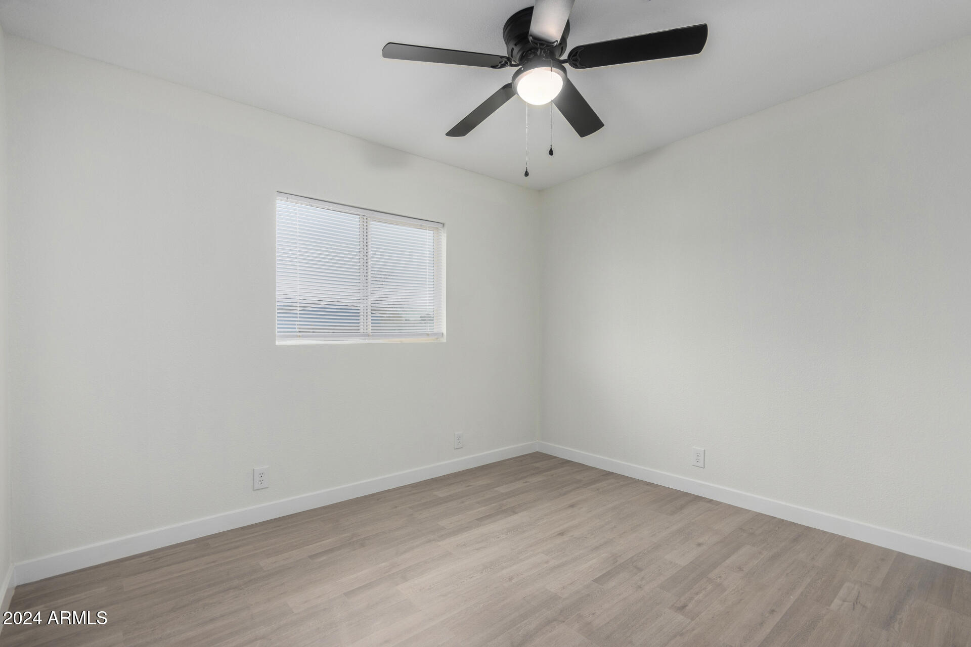 204 East Baseline Road Buckeye, AZ 85326 - Photo 18 of 29 an empty room with a window and a fan