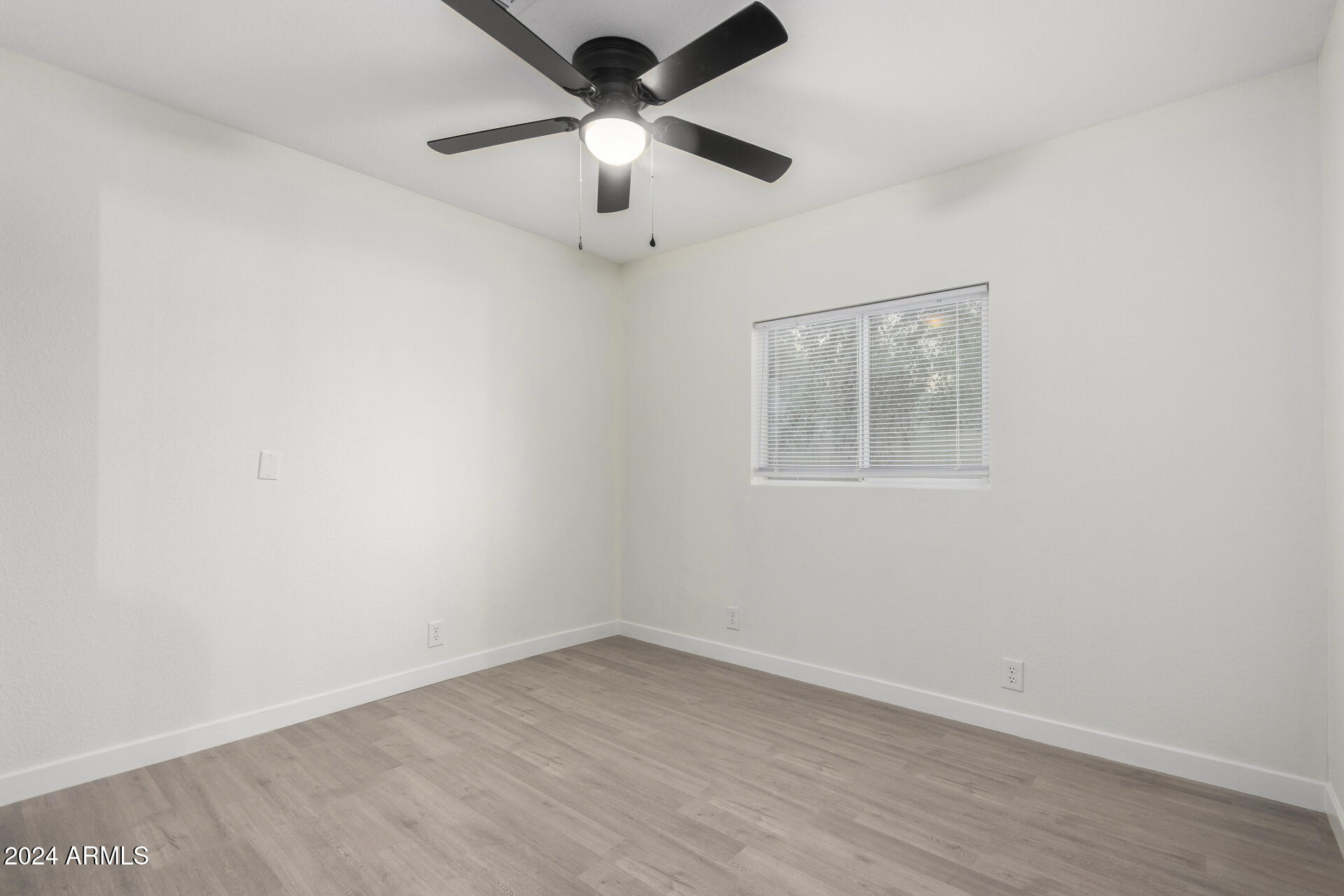 204 East Baseline Road Buckeye, AZ 85326 - Photo 21 of 29 an empty room with a window and a fan