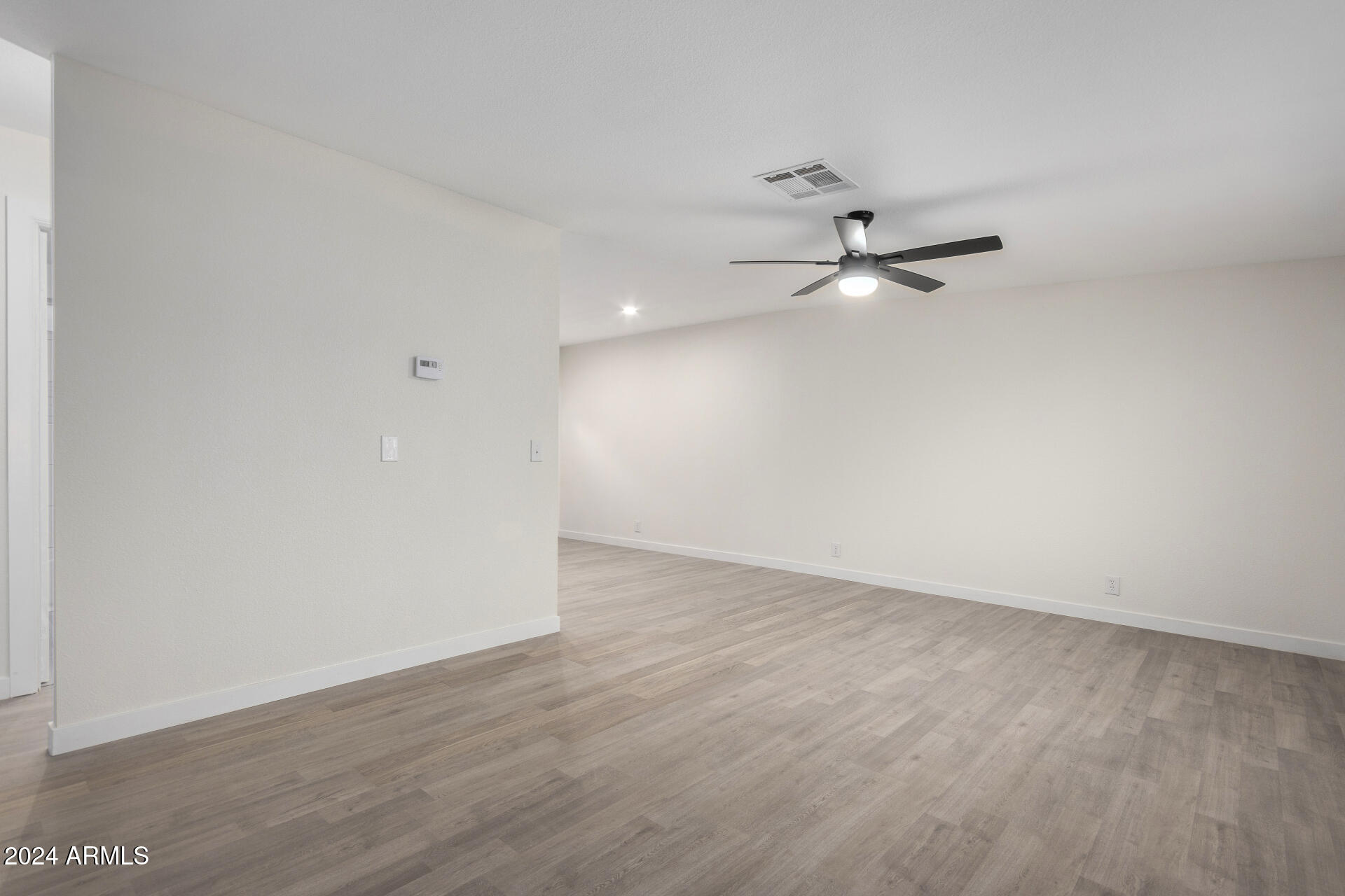 204 East Baseline Road Buckeye, AZ 85326 - Photo 4 of 29 wooden floor in an empty room