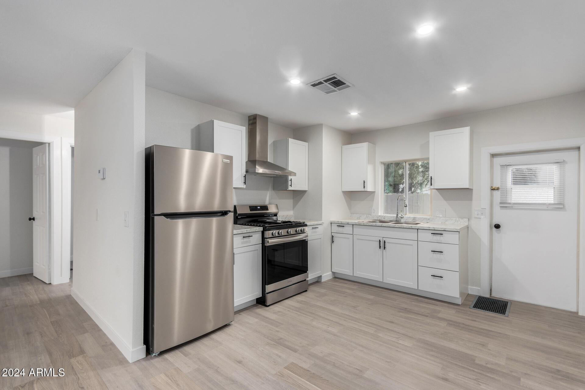 204 East Baseline Road Buckeye, AZ 85326 - Photo 8 of 29 a kitchen with a refrigerator stove a sink and dishwasher