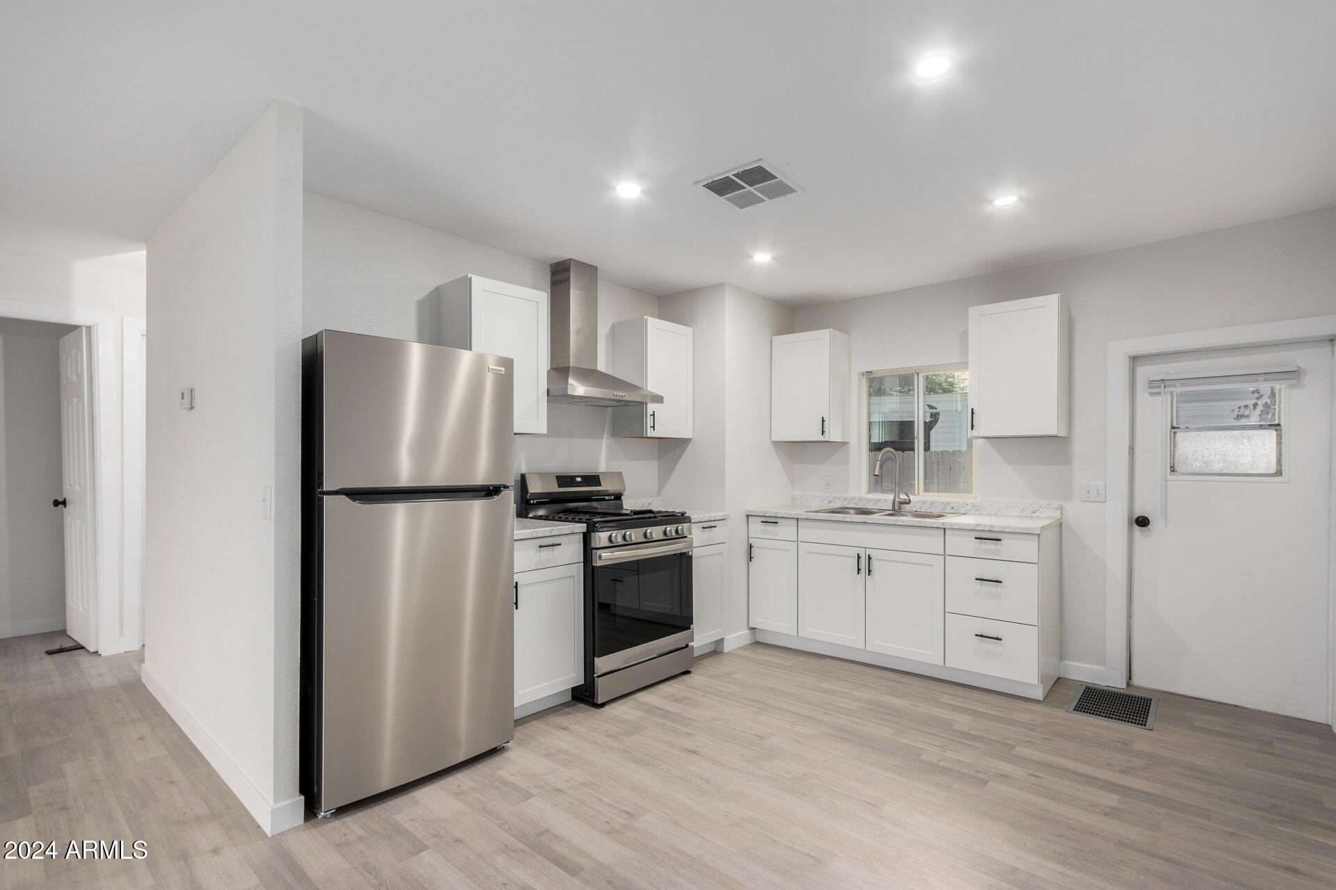 204 East Baseline Road Buckeye, AZ 85326 - Photo 9 of 29 a kitchen with a refrigerator sink and stove