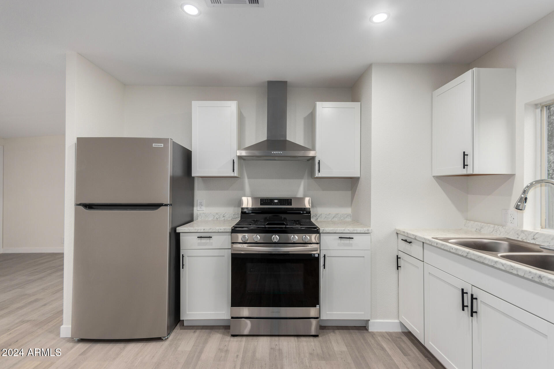 204 East Baseline Road Buckeye, AZ 85326 - Photo 10 of 29 a kitchen with a stove and refrigerator