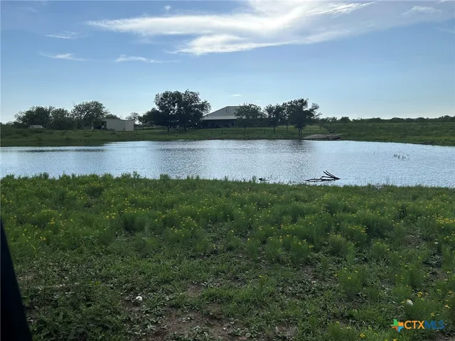 a view of field with trees in the background