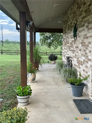 a garden with a table and a potted plant