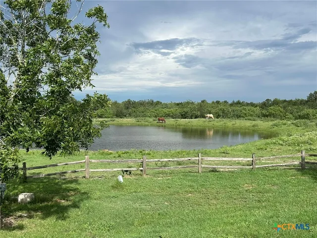 a view of a lake with houses in the background