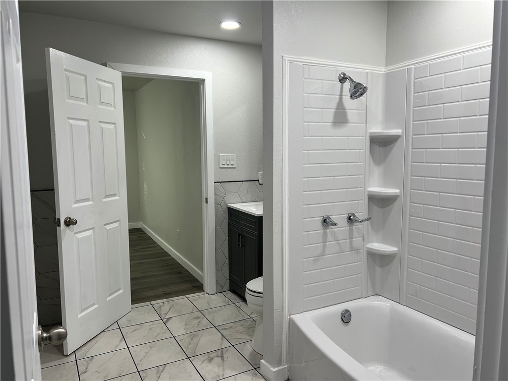 912 North Rife Street Aransas Pass, TX 78336 - Photo 11 of 23 a bathroom with a bathtub and a shower