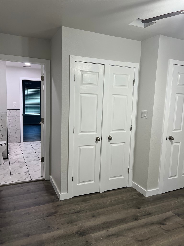 912 North Rife Street Aransas Pass, TX 78336 - Photo 12 of 23 a view of a hallway with wooden floor and closet area