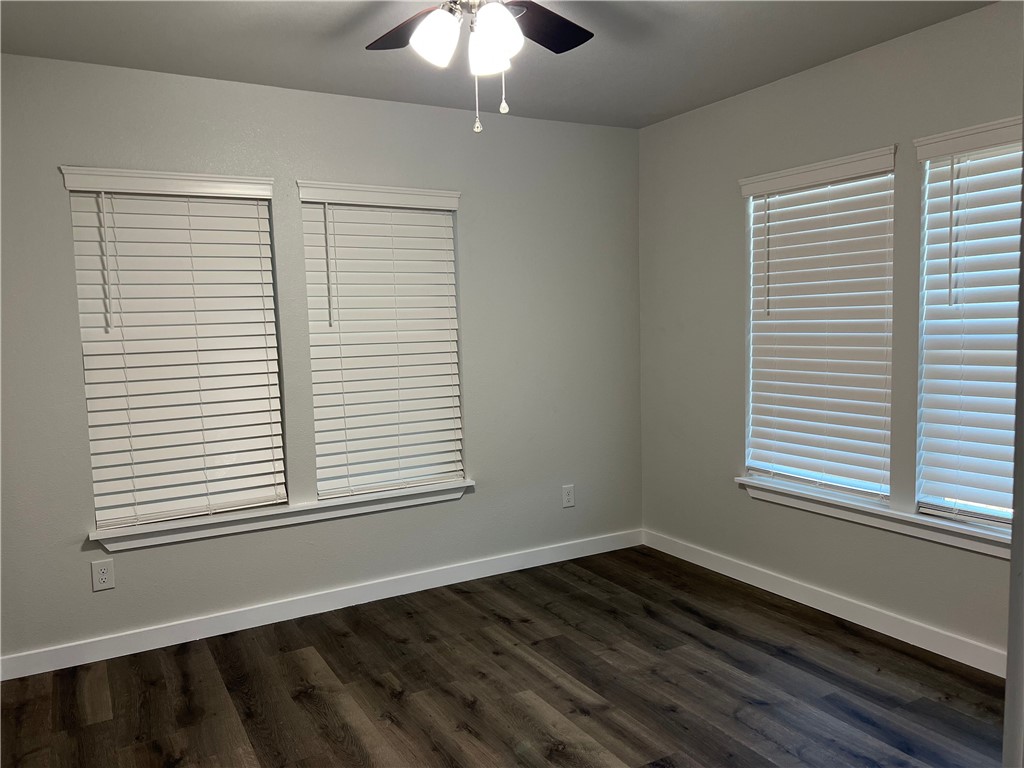 912 North Rife Street Aransas Pass, TX 78336 - Photo 16 of 23 an empty room with wooden floor and windows