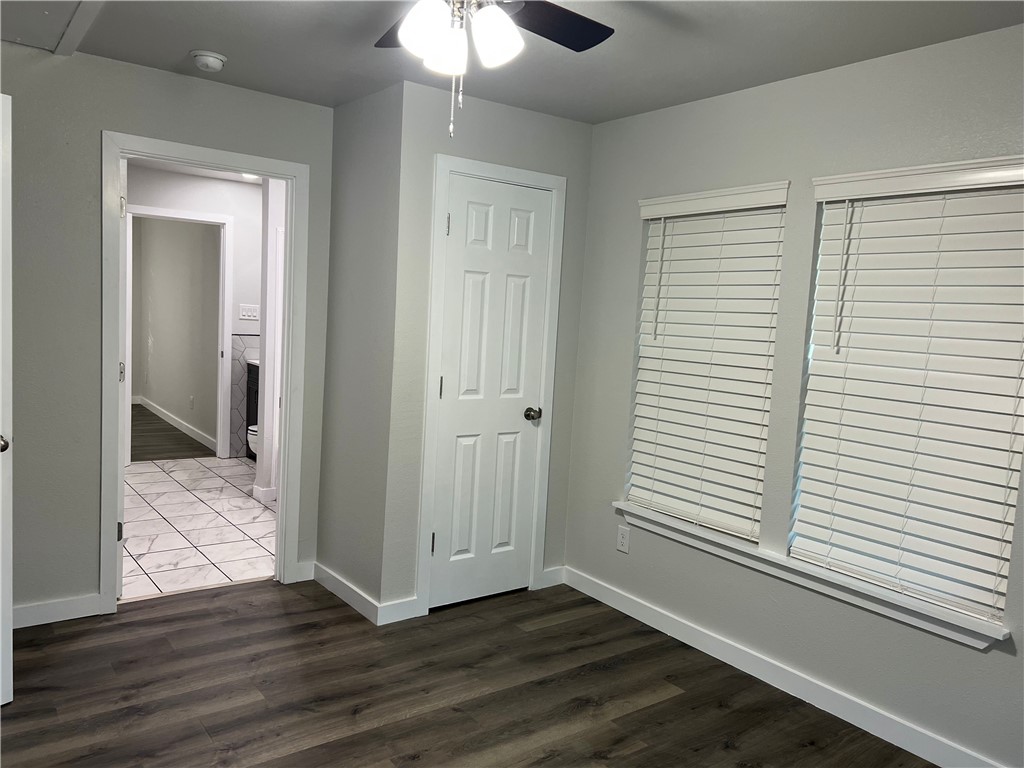 912 North Rife Street Aransas Pass, TX 78336 - Photo 17 of 23 a view of an empty room with wooden floor and a window