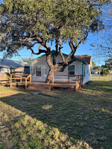 a view of a yard with wooden fence