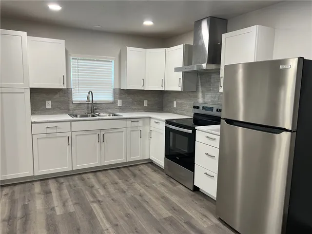 a view of a refrigerator in kitchen and wooden floor