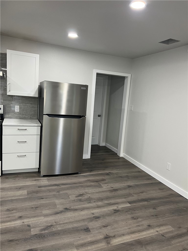 912 North Rife Street Aransas Pass, TX 78336 - Photo 8 of 23 a view of a refrigerator in kitchen and wooden floor