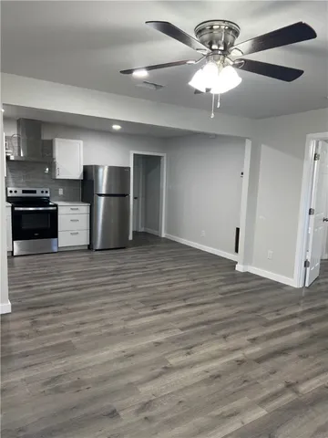 an empty room with wooden floor and closet
