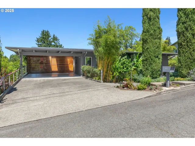 a front view of a house with a yard and a garage