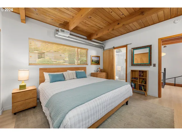 a bedroom with a large bed and a tv