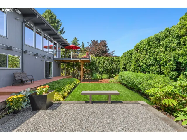a green field with flowers in front of it