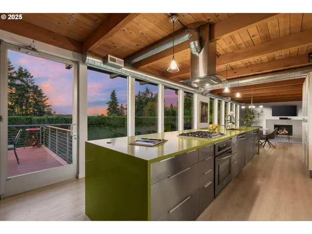 a kitchen with sink and view of living room